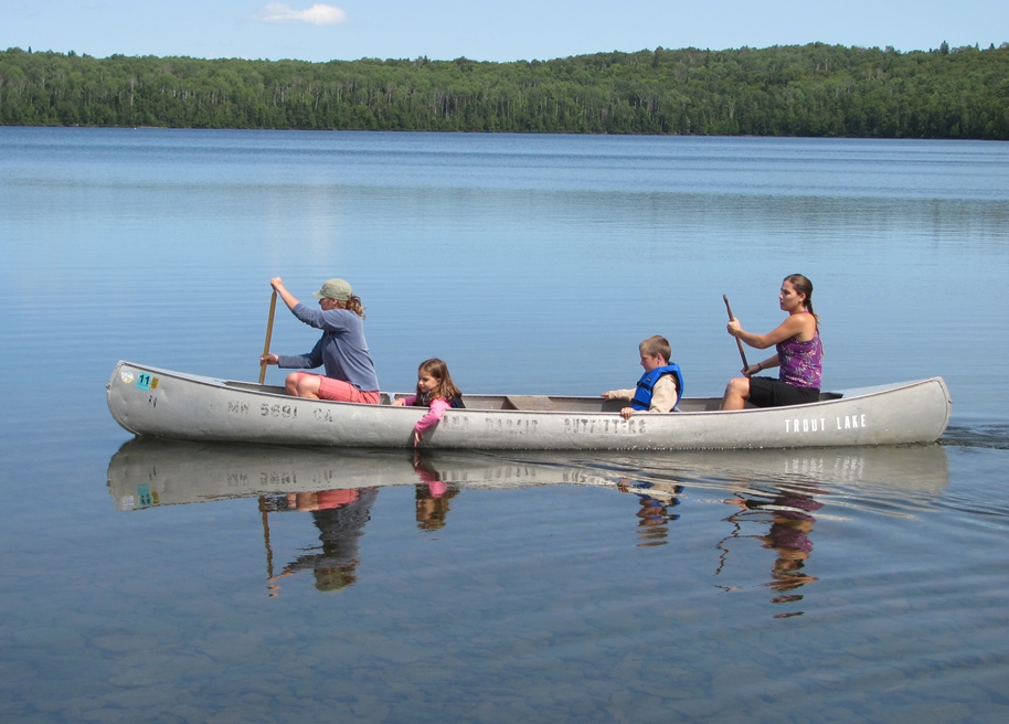 Paddling a Trout Lake Resort Canoe on Trout Lake. Kids are enjoying the ride.