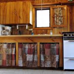 Cabin 1's kitchen has everything you need: refrigerator, stove, cupboards filled with cooking and eating supplies, a toaster and a coffee maker.